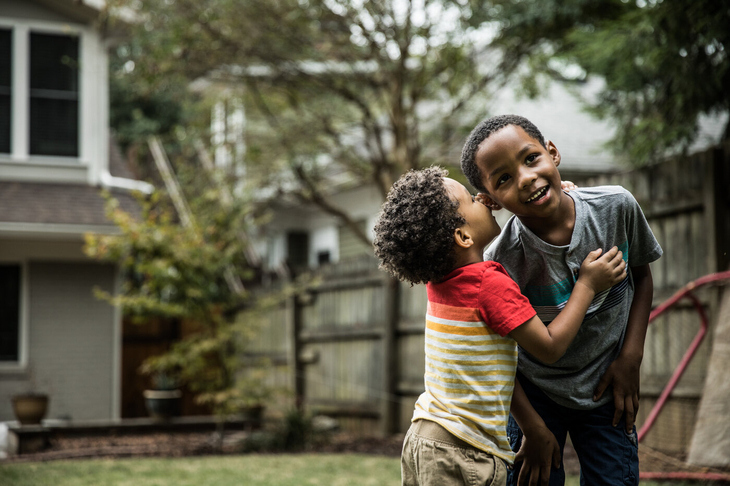 children whispering in garden